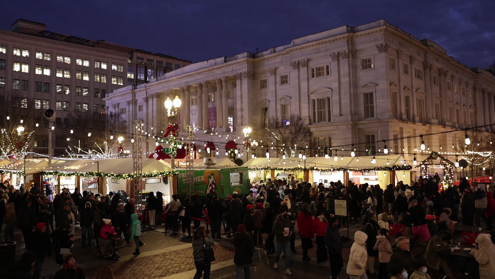 Holiday shoppers at the Penn Quarter DC holiday market in front of Monaco DC hotel