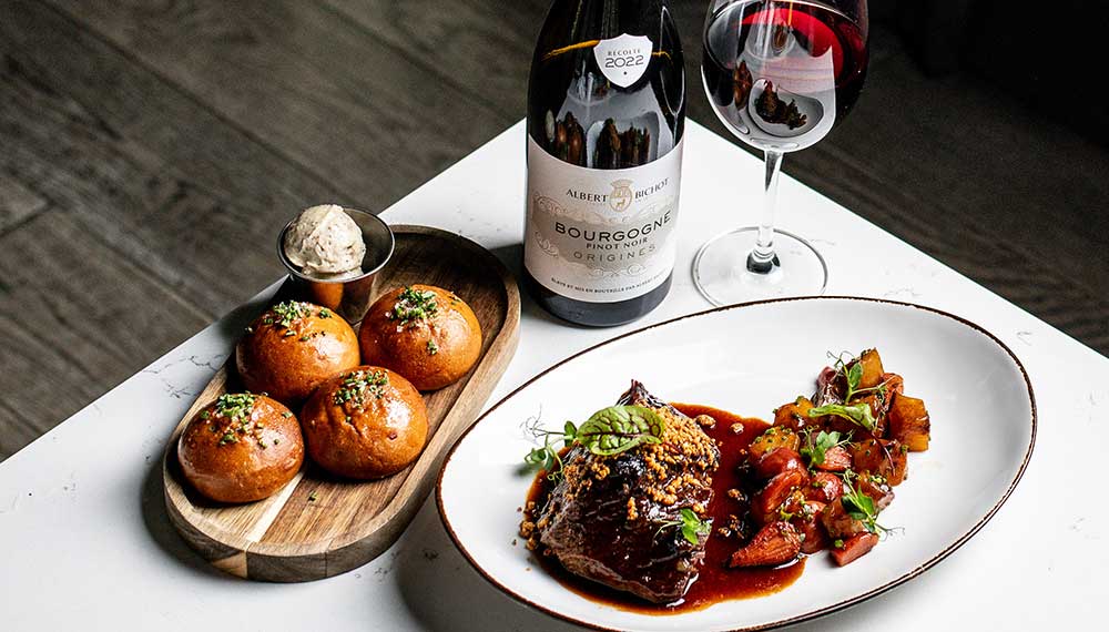 Red wine, rolls and steak