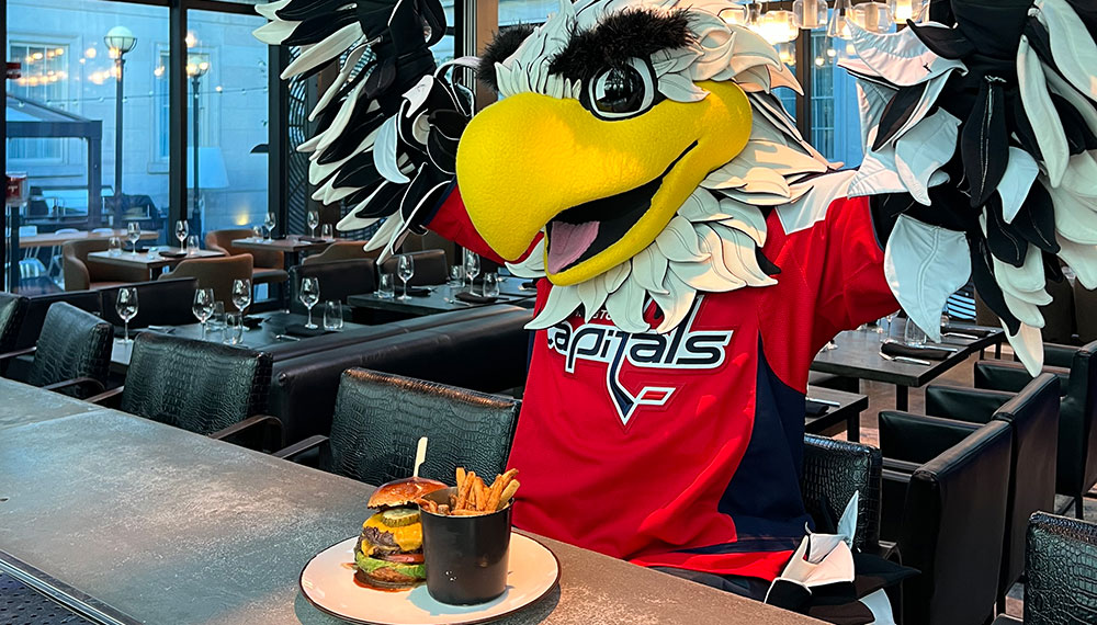 Capitals Mascot with a Buger and French Fries