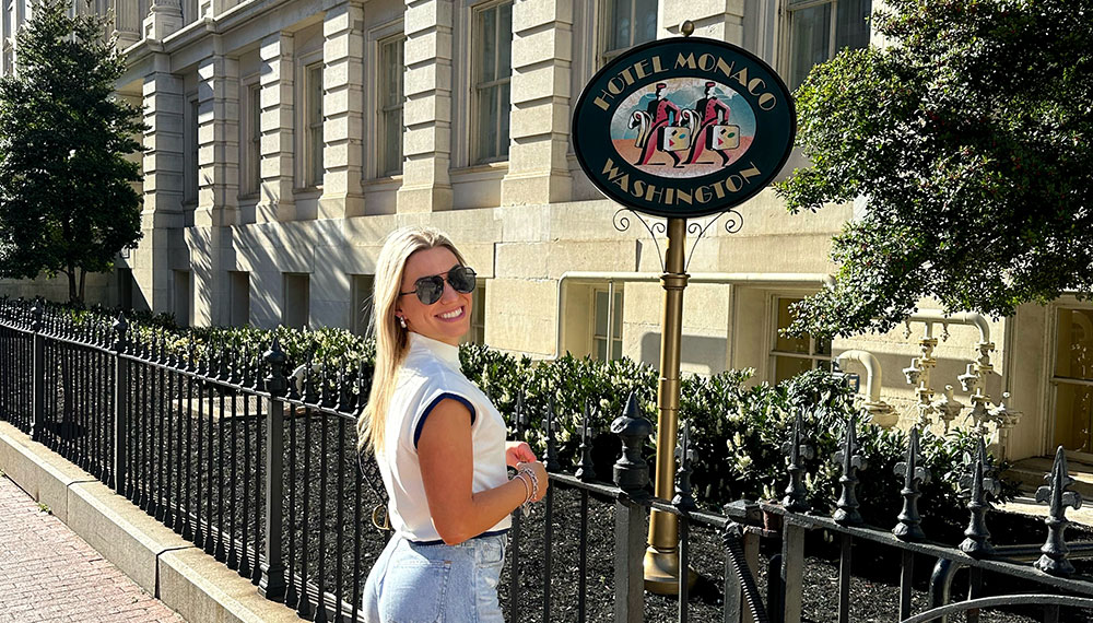 Woman standing in front of Monaco sign - by @chasebuckley