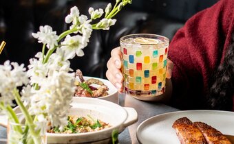 Cocktail and plates at Dirty Habit for Dine All Night